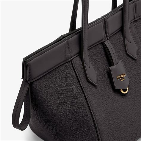 Black leather mini bag that can be transformed .